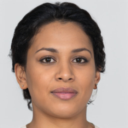 Joyful latino young-adult female with short  brown hair and brown eyes