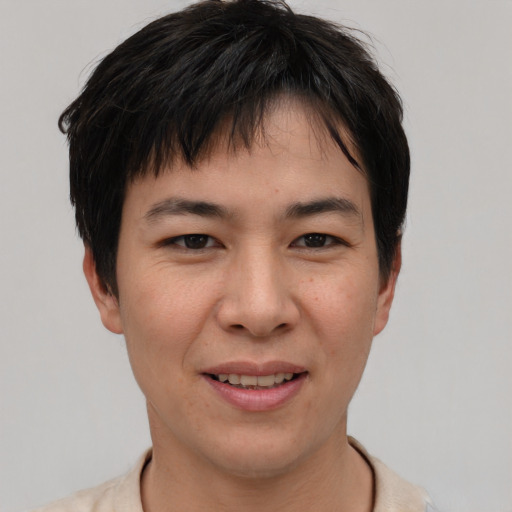 Joyful asian young-adult female with short  brown hair and brown eyes