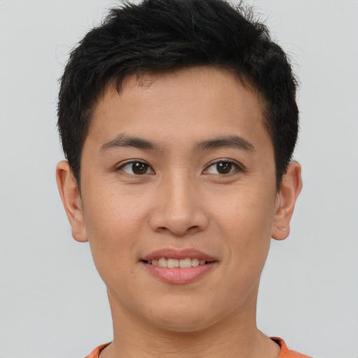 Joyful asian young-adult male with short  brown hair and brown eyes