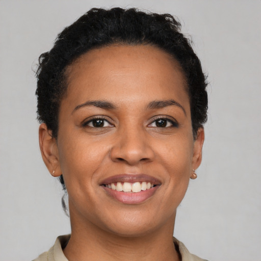 Joyful latino young-adult female with short  brown hair and brown eyes