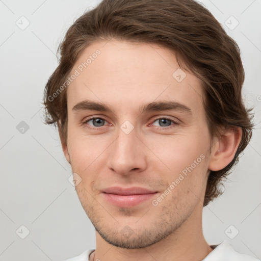 Joyful white young-adult male with short  brown hair and grey eyes