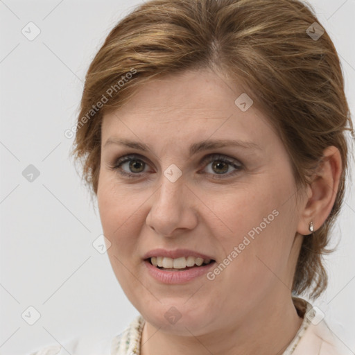 Joyful white adult female with medium  brown hair and brown eyes