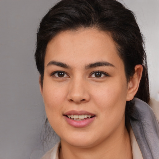 Joyful latino young-adult female with medium  brown hair and brown eyes
