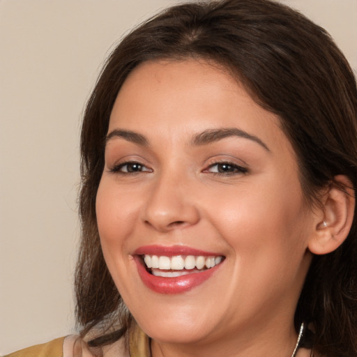 Joyful white young-adult female with medium  brown hair and brown eyes