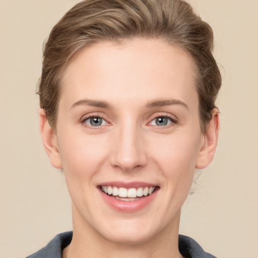 Joyful white young-adult female with short  brown hair and grey eyes