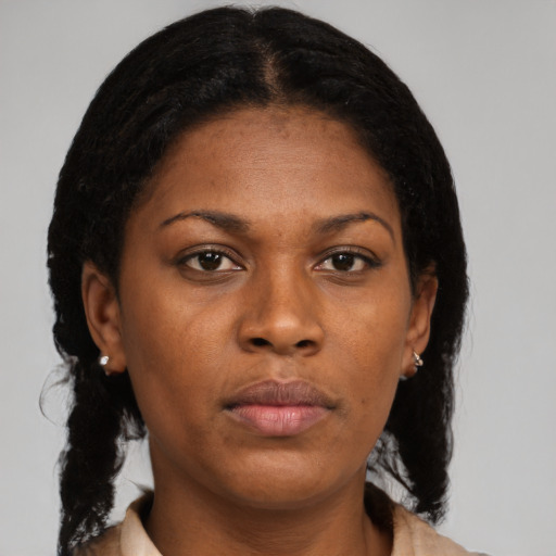 Neutral black young-adult female with medium  brown hair and brown eyes