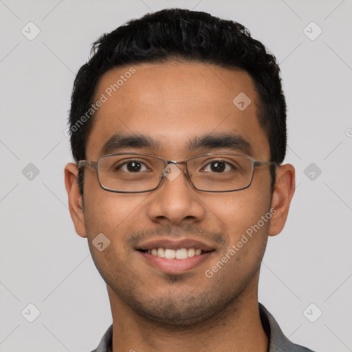 Joyful latino young-adult male with short  black hair and brown eyes