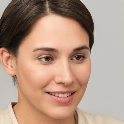 Joyful white young-adult female with short  brown hair and brown eyes