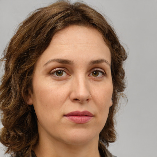 Joyful white young-adult female with medium  brown hair and green eyes