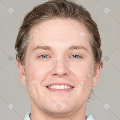 Joyful white adult male with short  brown hair and blue eyes