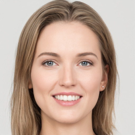 Joyful white young-adult female with long  brown hair and grey eyes