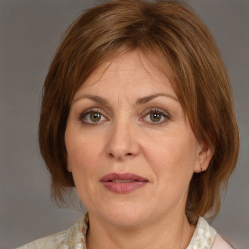 Joyful white adult female with medium  brown hair and grey eyes