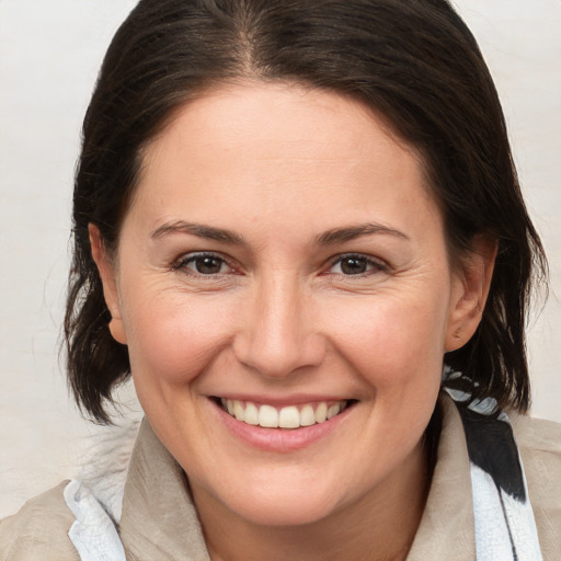 Joyful white adult female with medium  brown hair and brown eyes