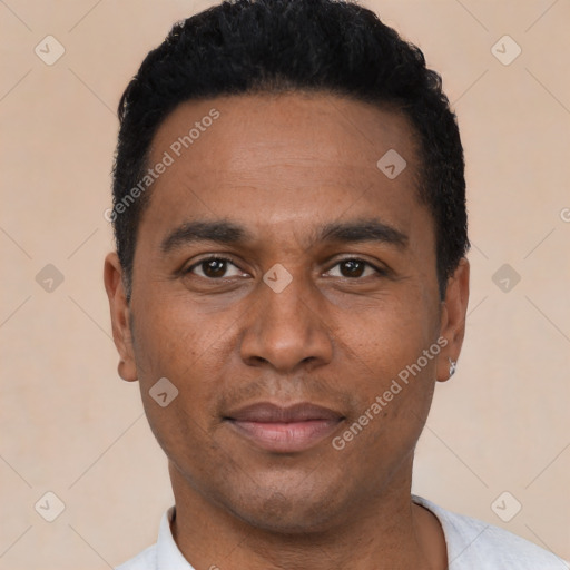 Joyful latino young-adult male with short  black hair and brown eyes