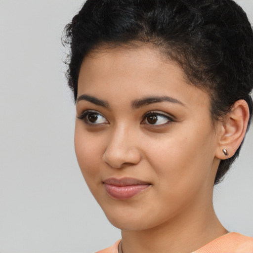 Joyful latino young-adult female with short  brown hair and brown eyes