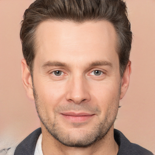 Joyful white adult male with short  brown hair and brown eyes