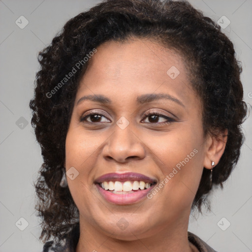 Joyful black young-adult female with medium  brown hair and brown eyes