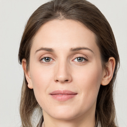 Joyful white young-adult female with long  brown hair and grey eyes