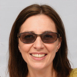 Joyful white young-adult female with medium  brown hair and blue eyes