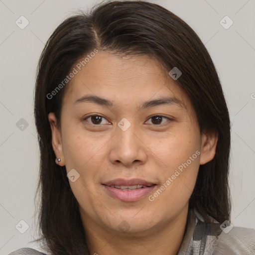 Joyful asian adult female with medium  brown hair and brown eyes