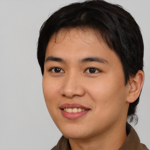 Joyful asian young-adult male with short  brown hair and brown eyes