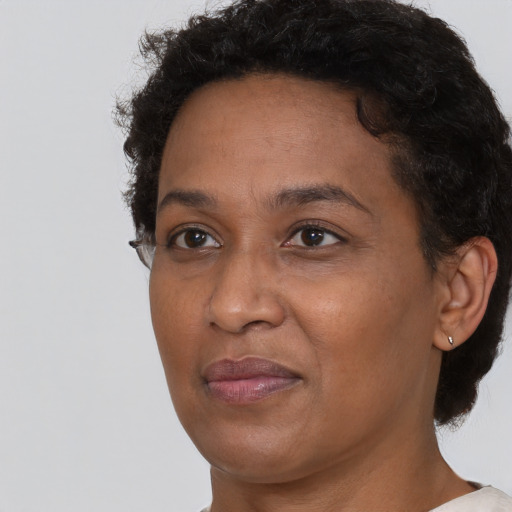 Joyful black adult female with short  brown hair and brown eyes