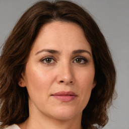 Joyful white young-adult female with medium  brown hair and green eyes