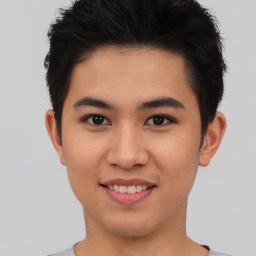 Joyful asian young-adult male with short  brown hair and brown eyes