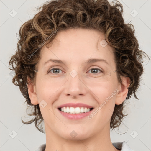 Joyful white young-adult female with medium  brown hair and green eyes