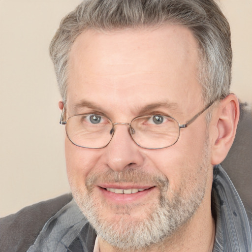 Joyful white middle-aged male with short  gray hair and grey eyes