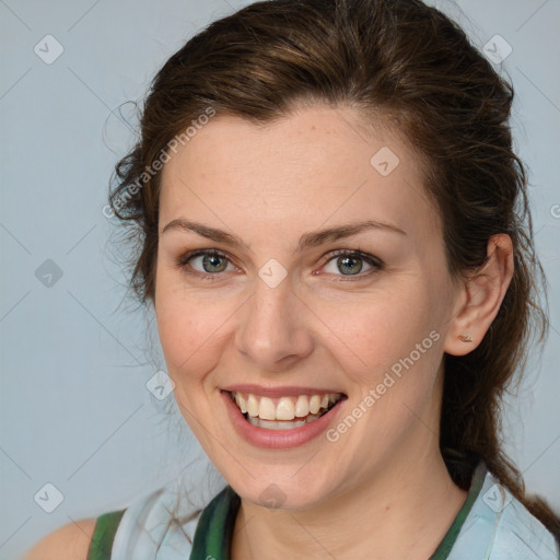 Joyful white young-adult female with medium  brown hair and green eyes