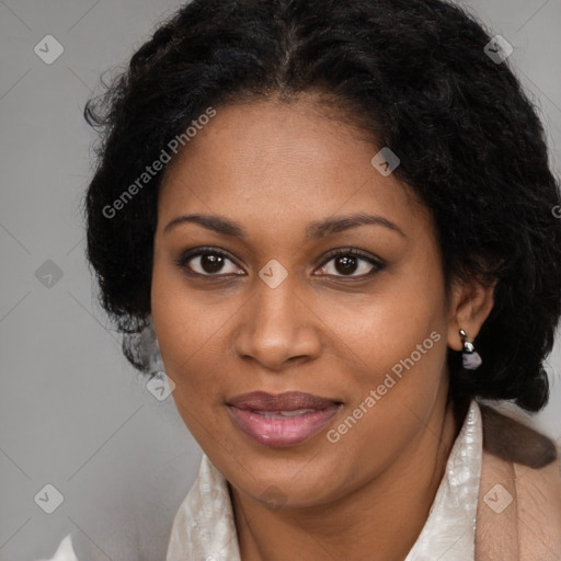 Joyful black adult female with long  brown hair and brown eyes