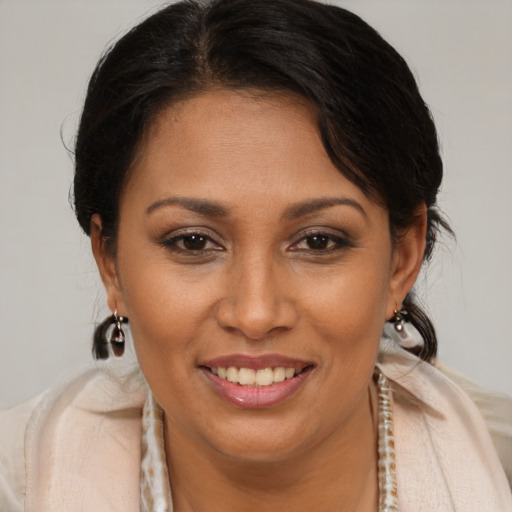 Joyful latino young-adult female with medium  brown hair and brown eyes