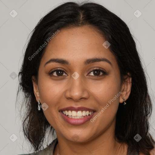 Joyful latino young-adult female with long  brown hair and brown eyes