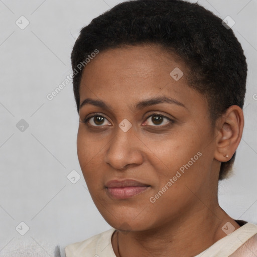 Joyful black young-adult female with short  black hair and brown eyes