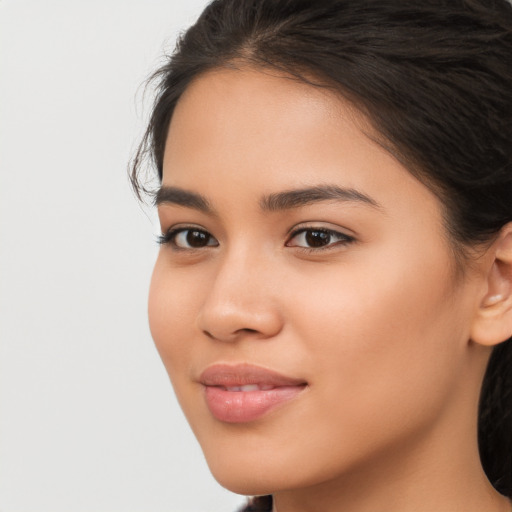 Joyful latino young-adult female with long  brown hair and brown eyes