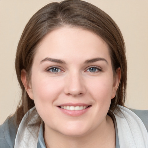 Joyful white young-adult female with medium  brown hair and grey eyes