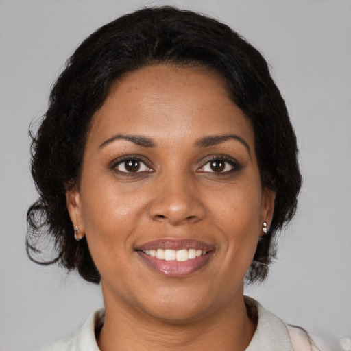 Joyful black young-adult female with medium  brown hair and brown eyes