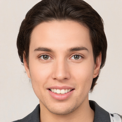 Joyful white young-adult male with medium  brown hair and brown eyes