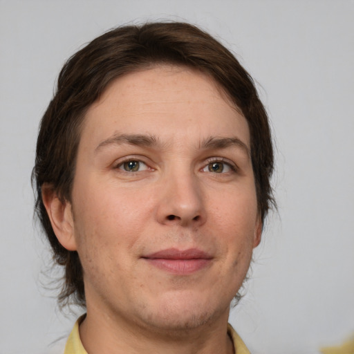 Joyful white adult female with medium  brown hair and brown eyes