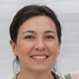 Joyful white young-adult female with medium  brown hair and brown eyes