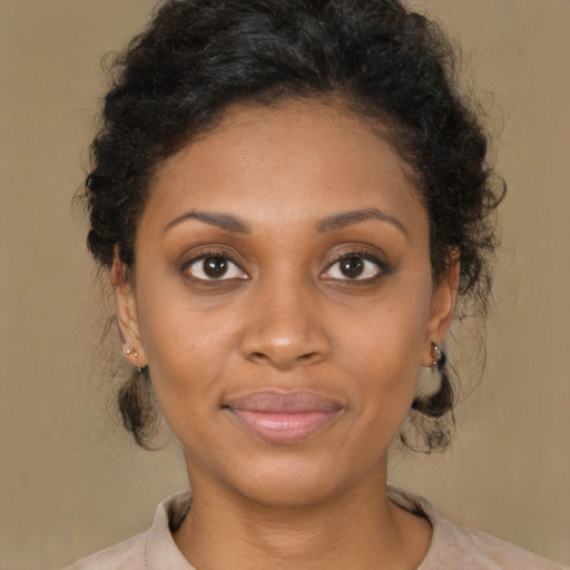 Joyful black young-adult female with medium  brown hair and brown eyes