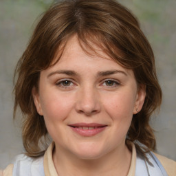 Joyful white young-adult female with medium  brown hair and blue eyes