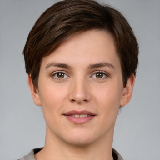 Joyful white young-adult female with short  brown hair and grey eyes