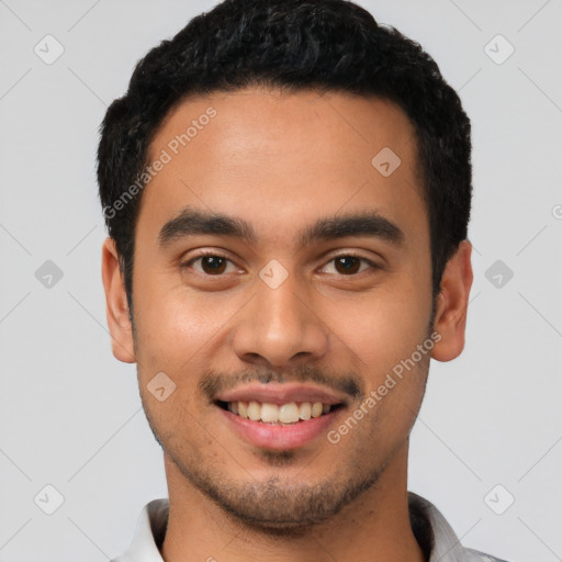 Joyful latino young-adult male with short  black hair and brown eyes