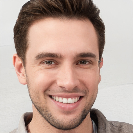 Joyful white young-adult male with short  brown hair and brown eyes