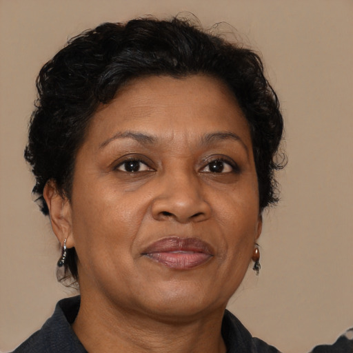 Joyful black adult female with medium  brown hair and brown eyes