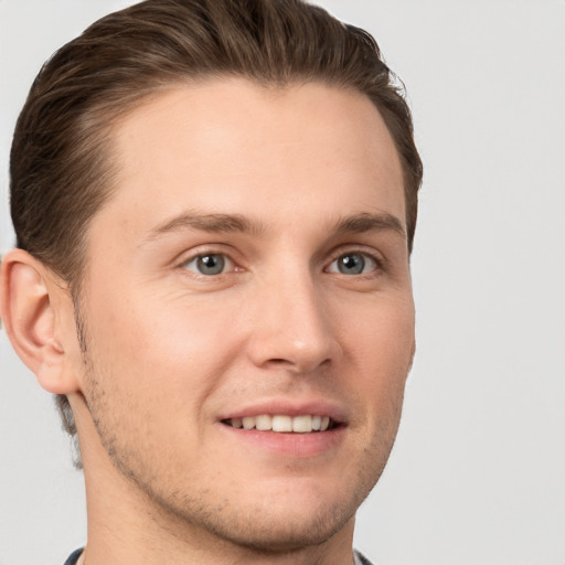 Joyful white young-adult male with short  brown hair and grey eyes