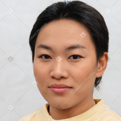 Joyful asian young-adult female with short  brown hair and brown eyes