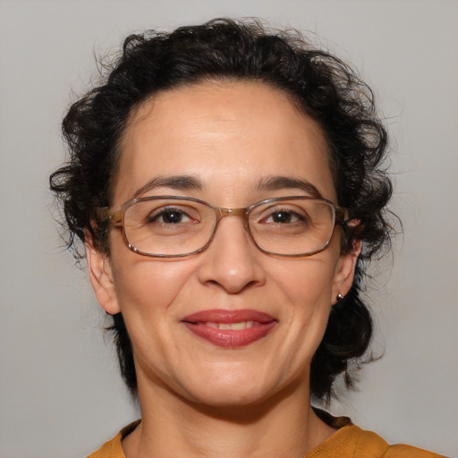 Joyful latino adult female with medium  brown hair and brown eyes